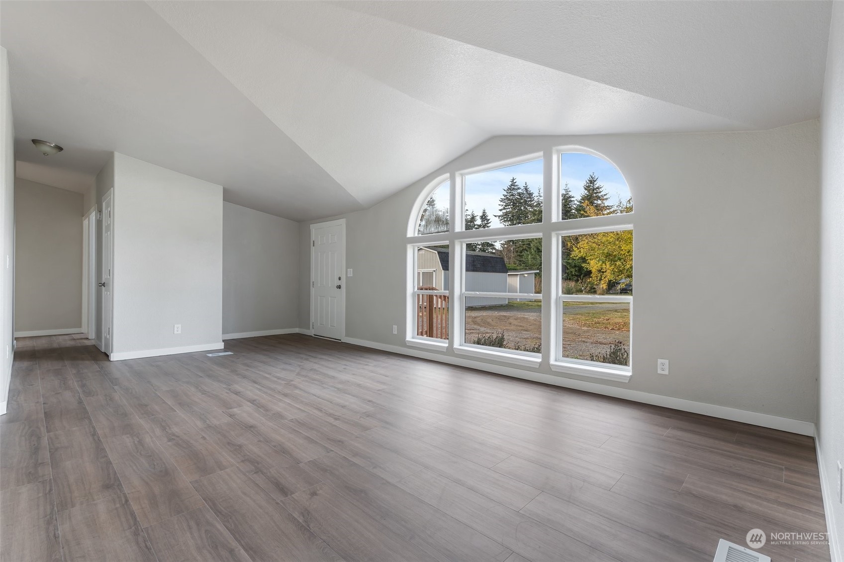 18740 Ivan Street Southwest Rochester, WA 98579 - Photo 4 of 39 an empty room with wooden floor and door