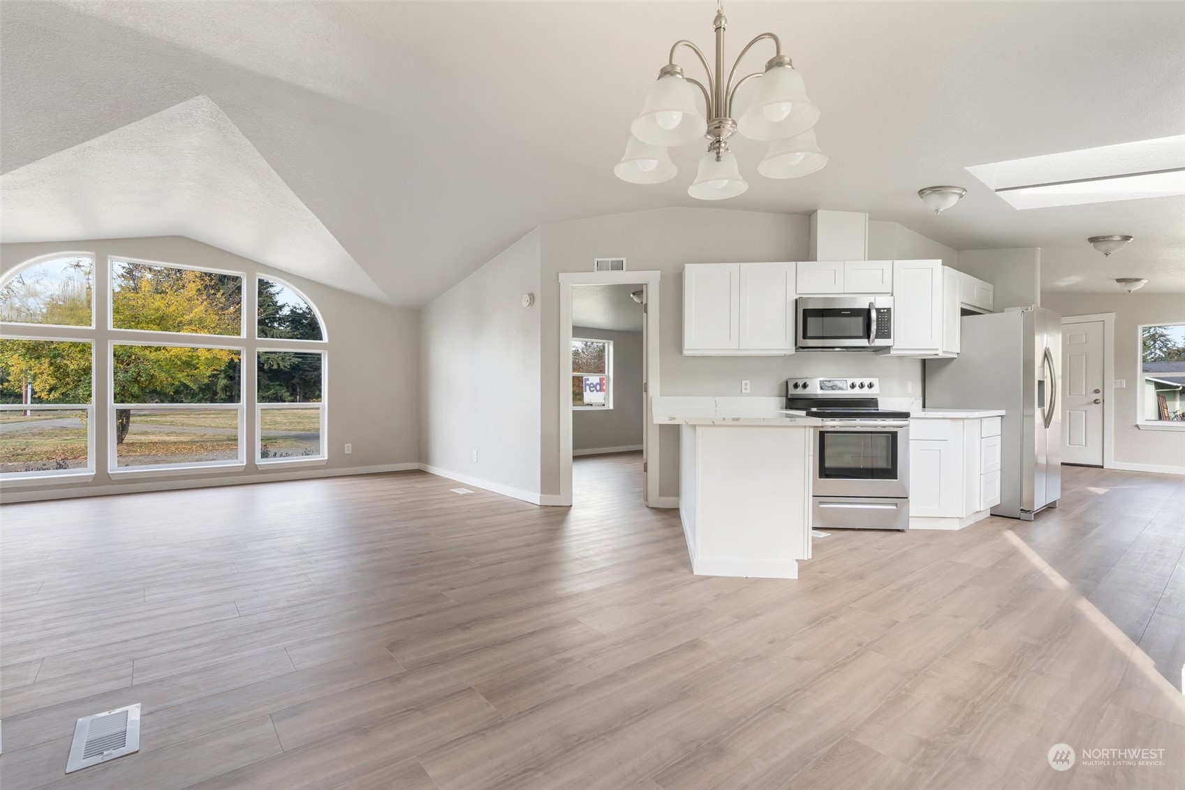 18740 Ivan Street Southwest Rochester, WA 98579 - Photo 5 of 39 a view of kitchen with stainless steel appliances granite countertop a stove top oven a refrigerator a sink and dishwasher with wooden floor