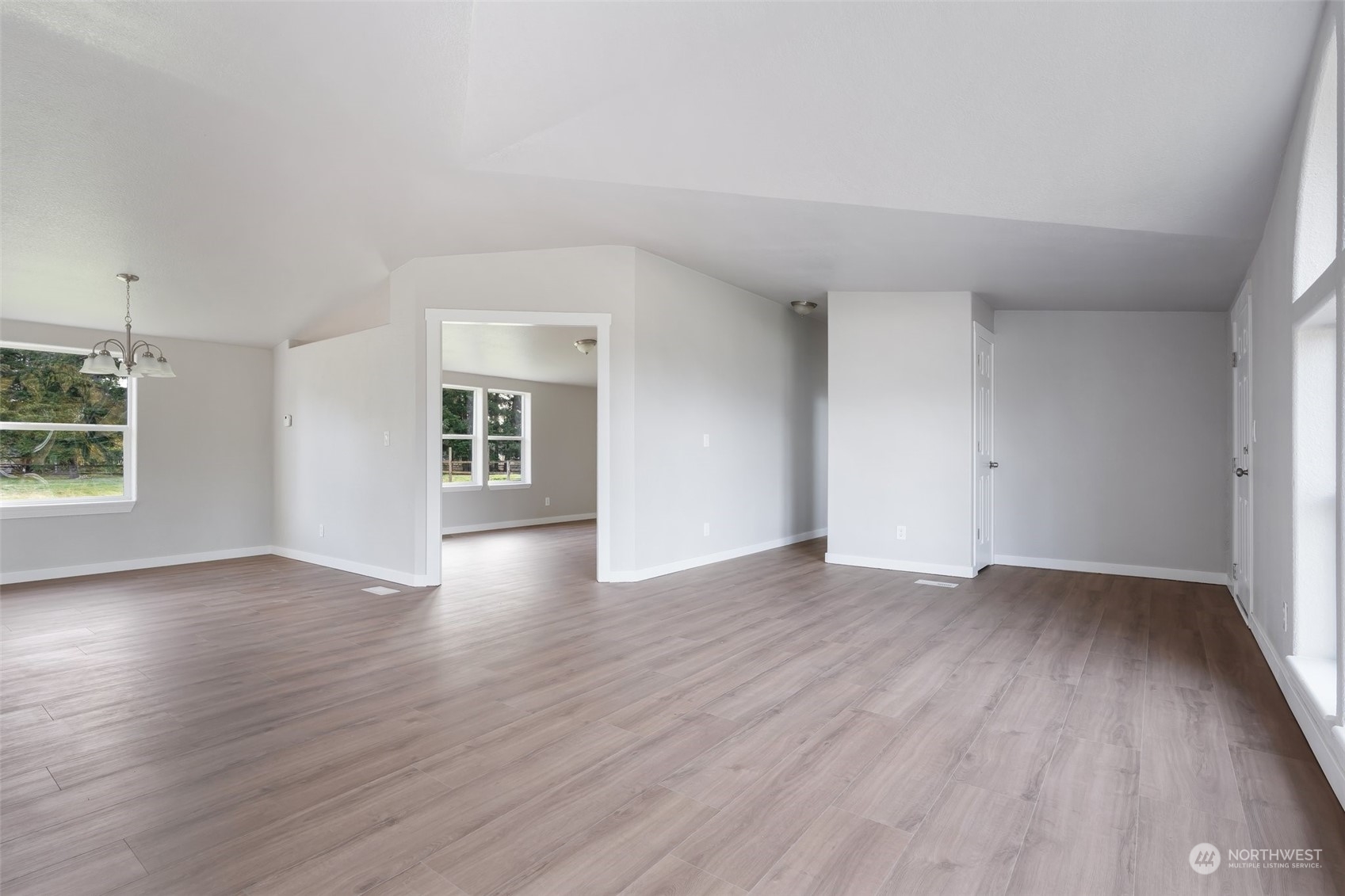 18740 Ivan Street Southwest Rochester, WA 98579 - Photo 6 of 39 an empty room with wooden floor and windows