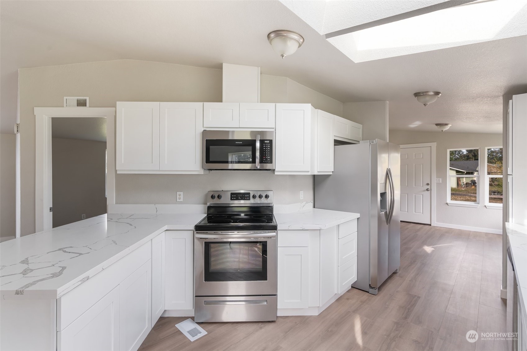 18740 Ivan Street Southwest Rochester, WA 98579 - Photo 10 of 39 a kitchen with stainless steel appliances a stove microwave and sink