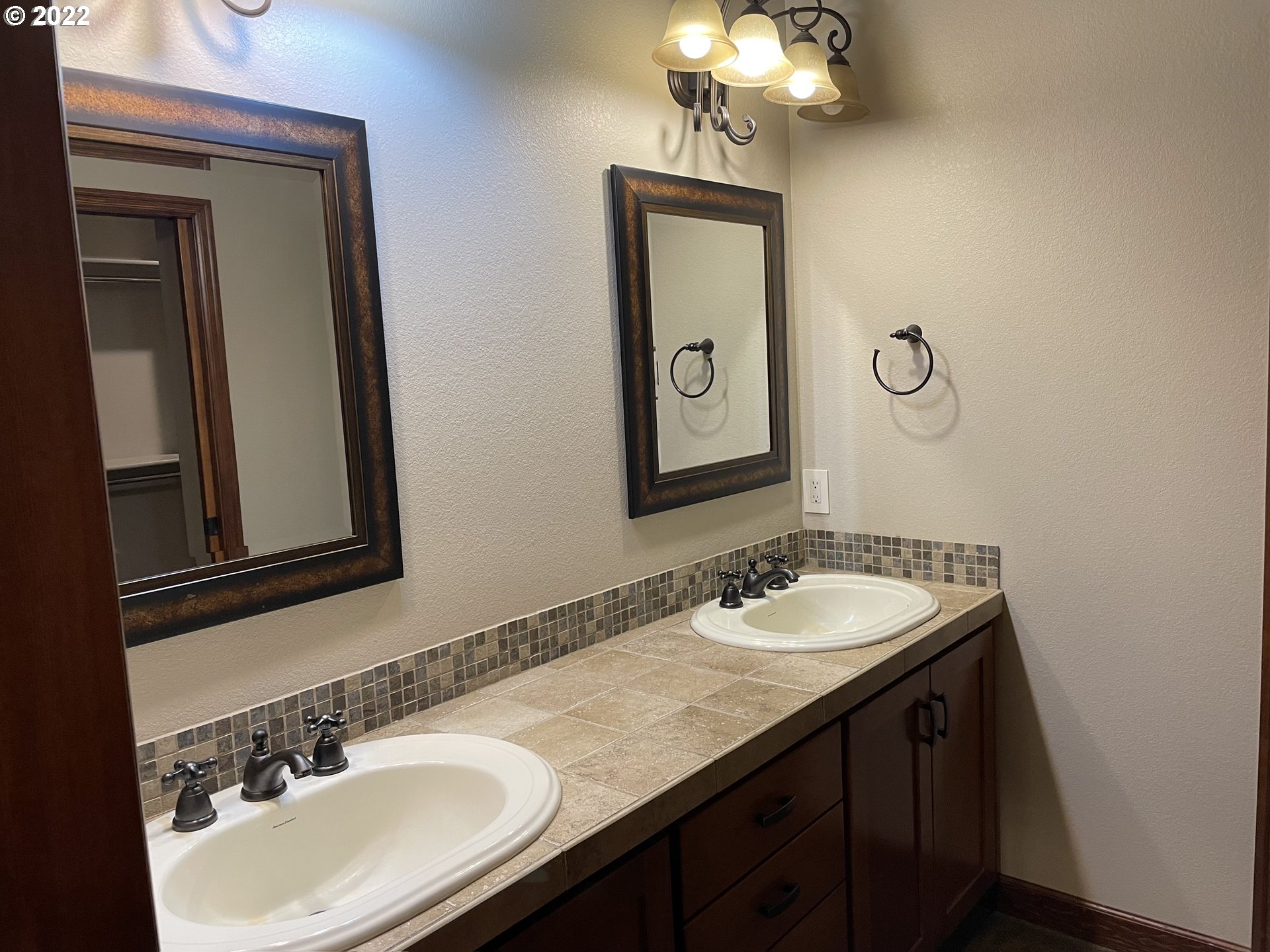 3247 Lake Crest Drive Eugene, OR 97408 - Photo 19 of 31 a bathroom with a granite countertop sink and a mirror