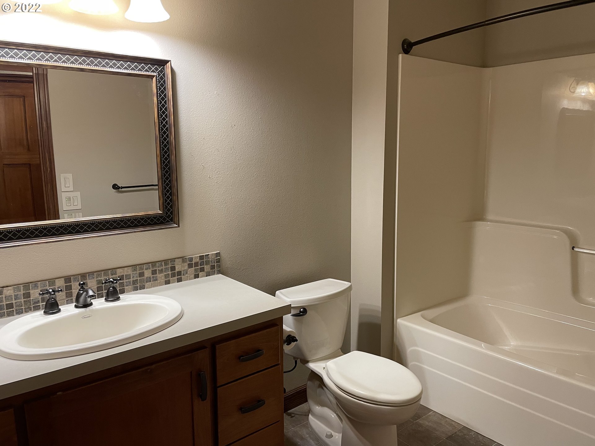 3247 Lake Crest Drive Eugene, OR 97408 - Photo 26 of 31 a bathroom with a sink a toilet a mirror and shower