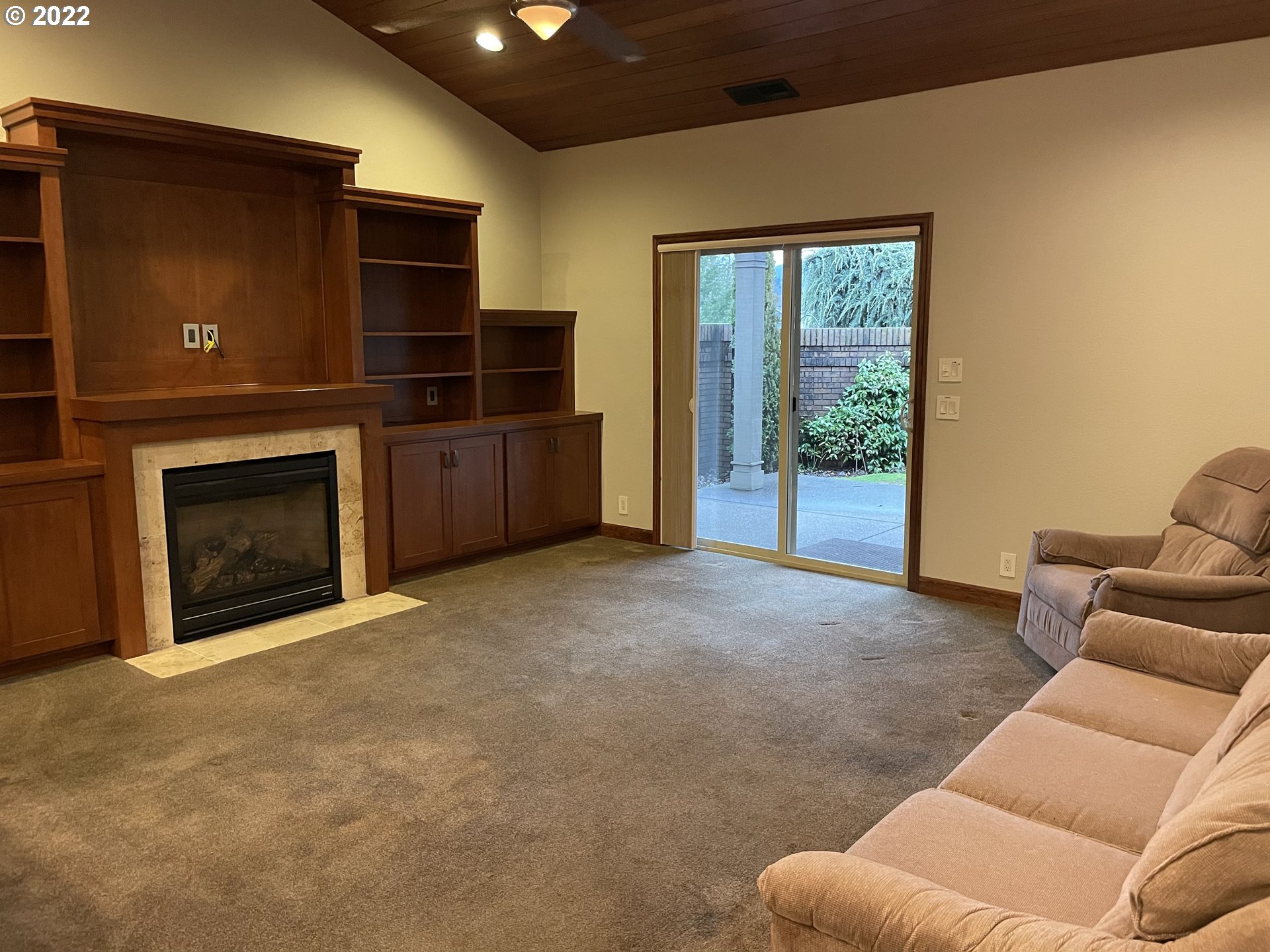 3247 Lake Crest Drive Eugene, OR 97408 - Photo 9 of 31 a living room with furniture a fireplace and a flat screen tv