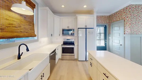 a kitchen with stainless steel appliances a refrigerator and a sink