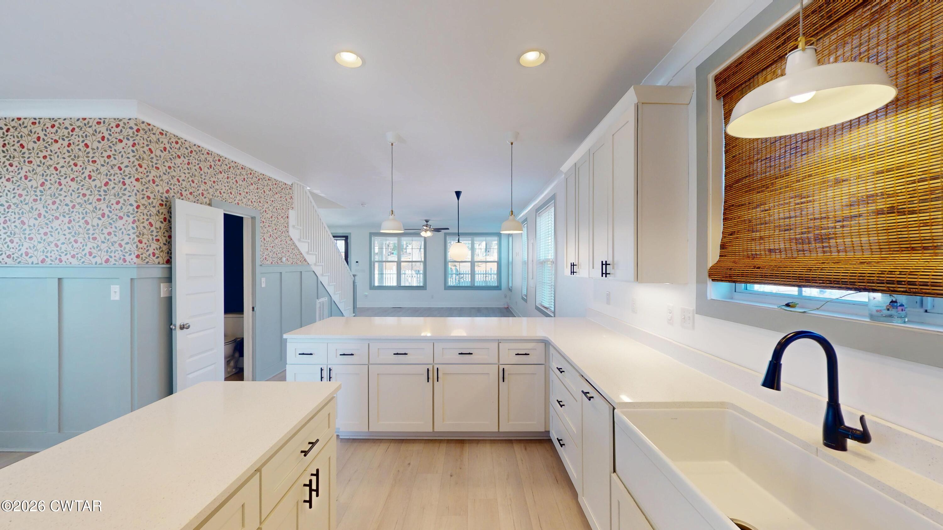 226 Morgan Street Jackson, TN 38301 - Photo 16 of 51 a large white kitchen with a sink a refrigerator and window