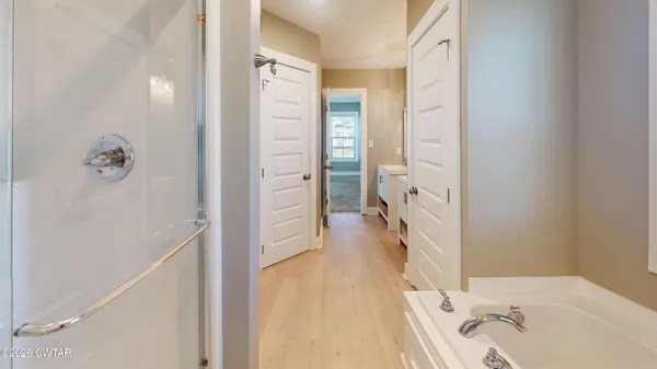 a bathroom with a glass shower door and a shower