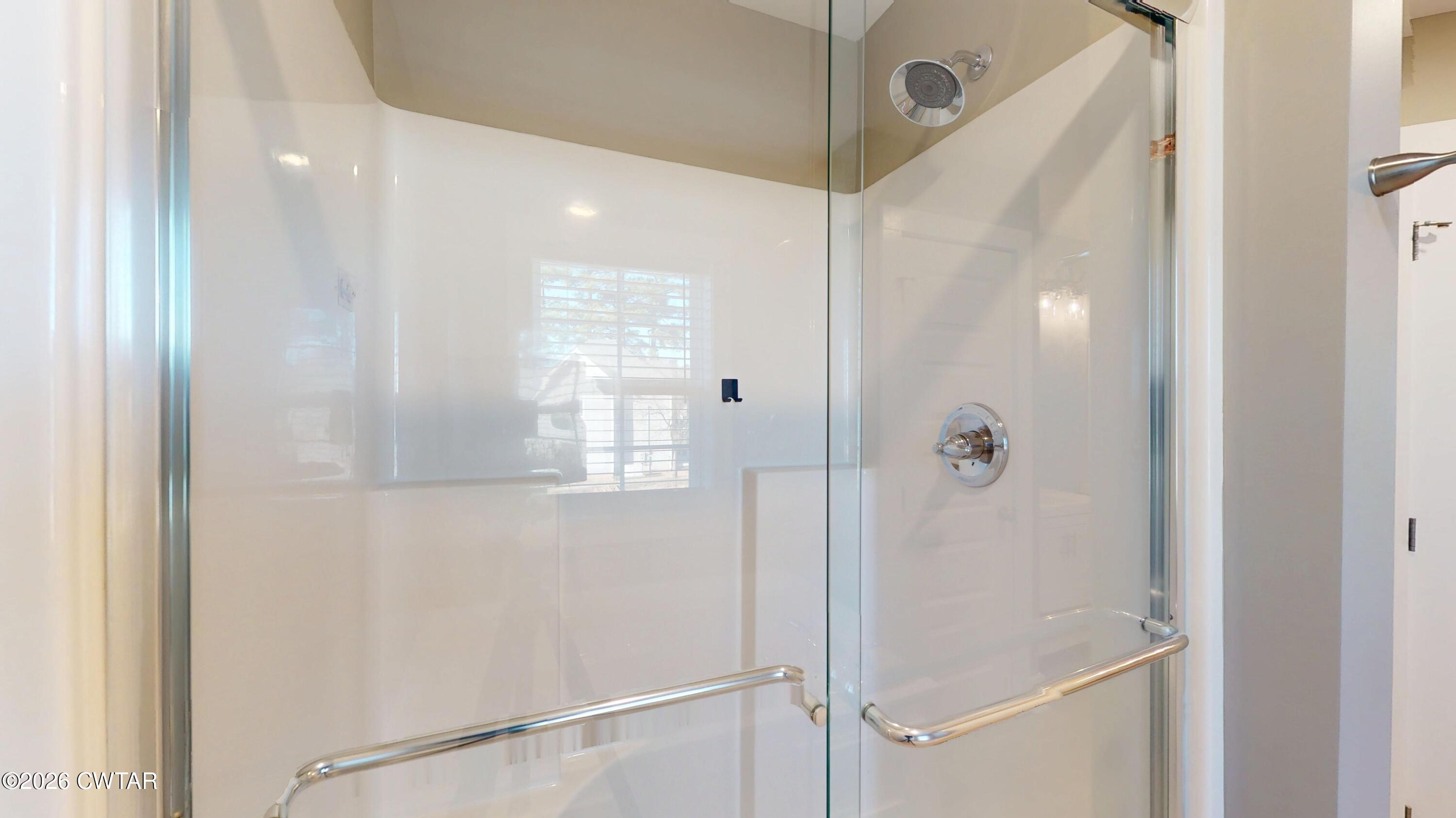 226 Morgan Street Jackson, TN 38301 - Photo 24 of 51 a bathroom with a glass shower door and a shower