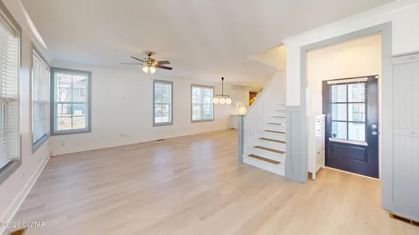 an empty room with windows and entryway