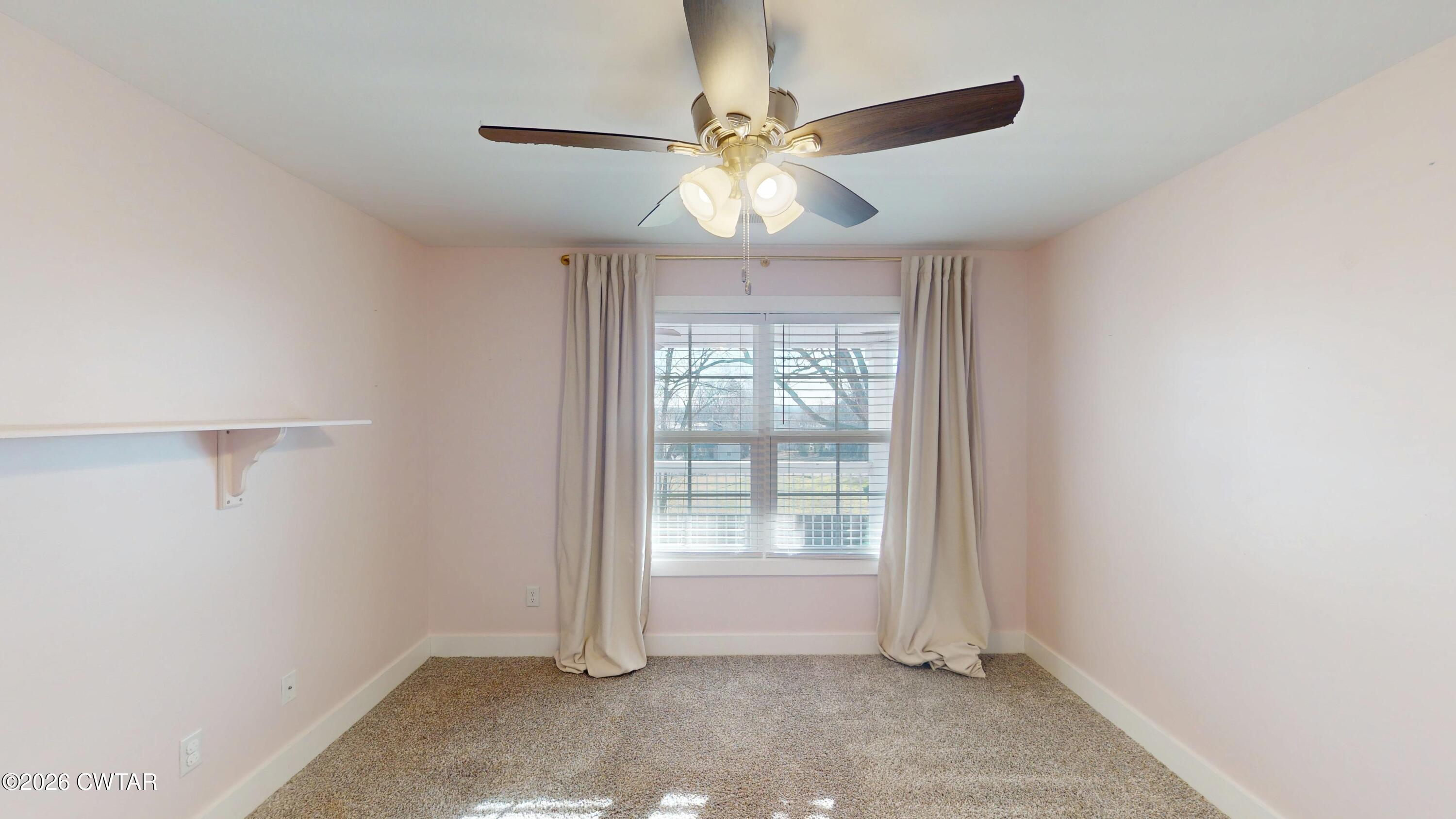 226 Morgan Street Jackson, TN 38301 - Photo 32 of 51 an empty room with windows and fan