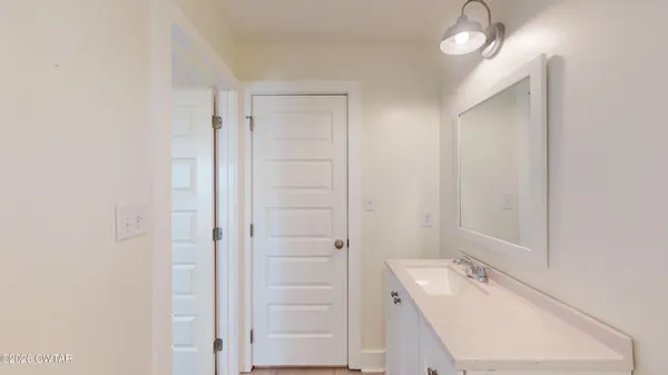 an empty room with closet and windows