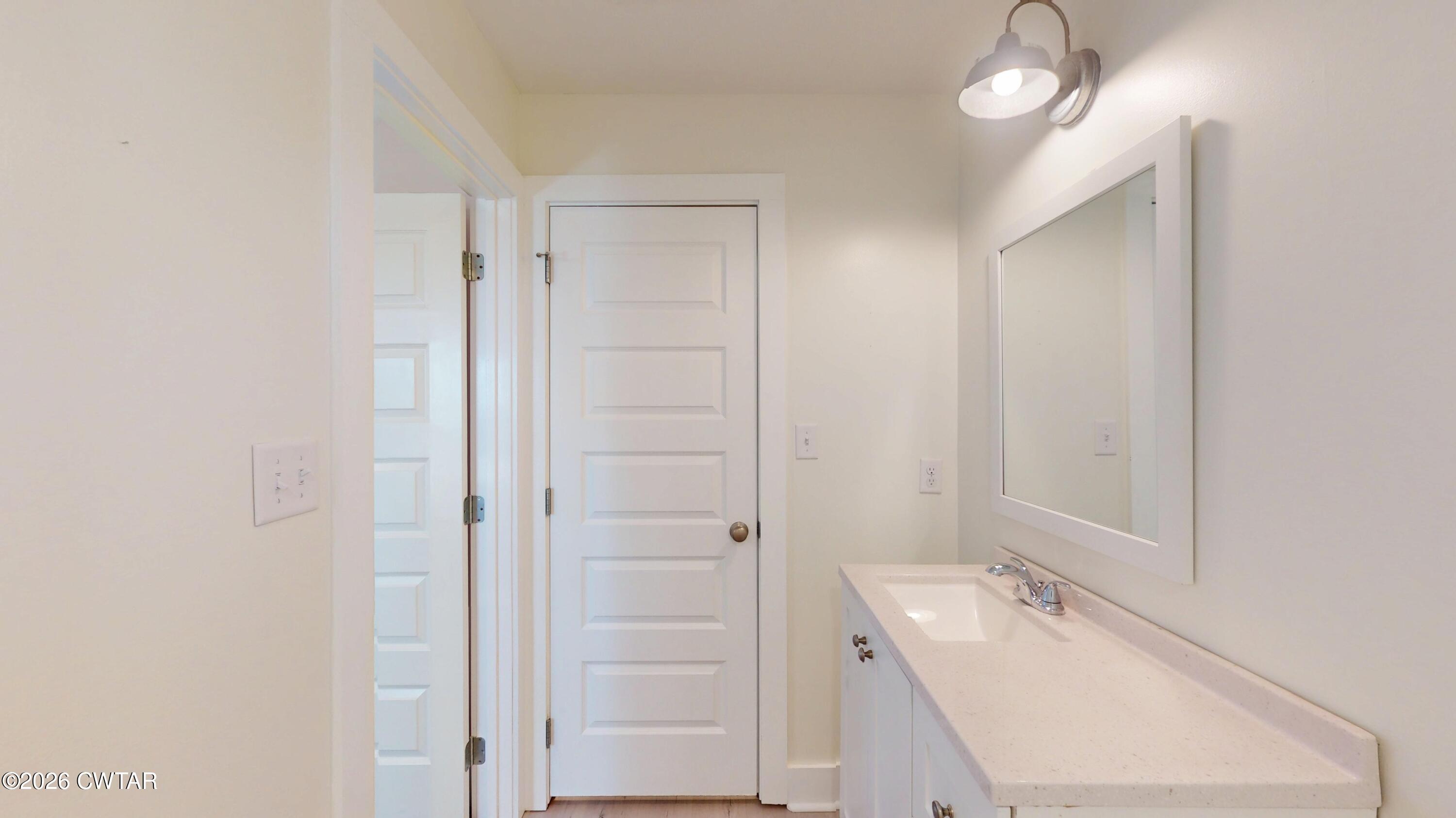 226 Morgan Street Jackson, TN 38301 - Photo 34 of 51 a bathroom with a tub a sink and mirrors