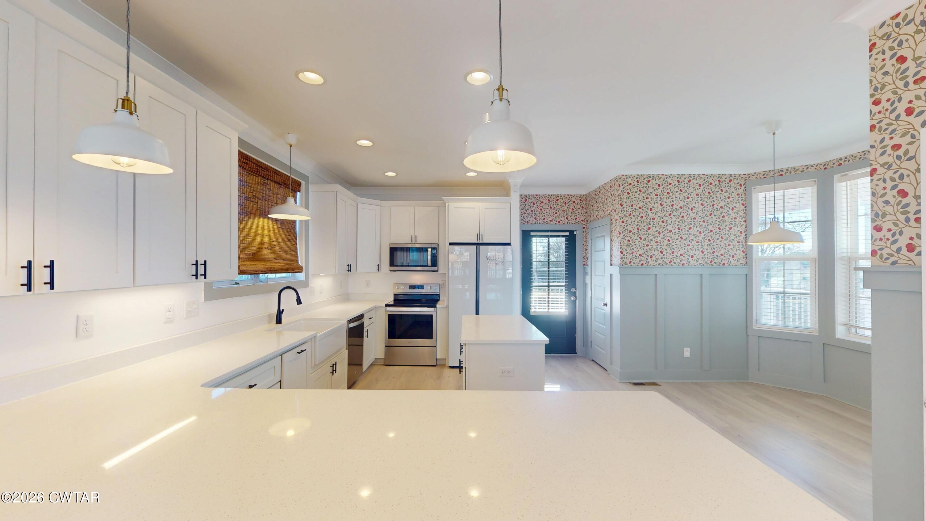 226 Morgan Street Jackson, TN 38301 - Photo 10 of 51 a large kitchen with a large window a sink and stainless steel appliances