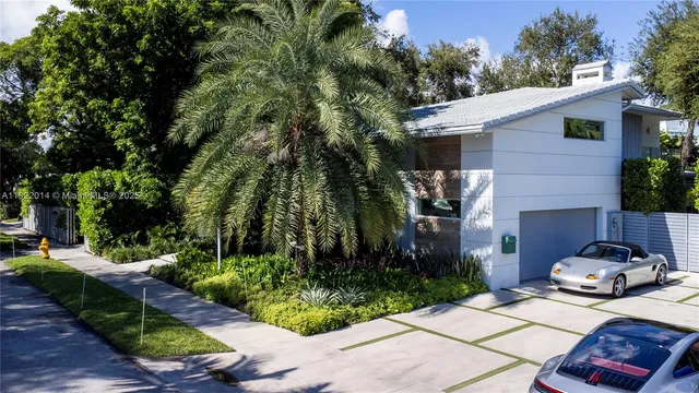 a car parked in front of a white house