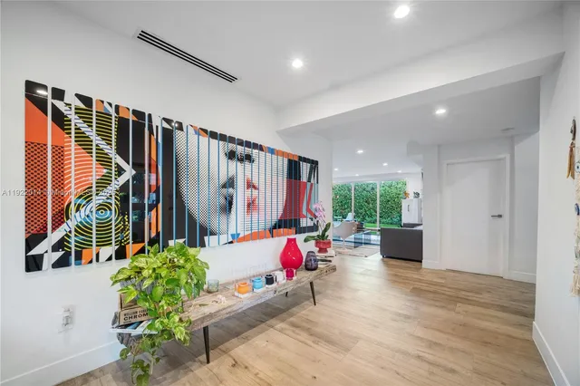 a living room with fireplace furniture and a potted plant