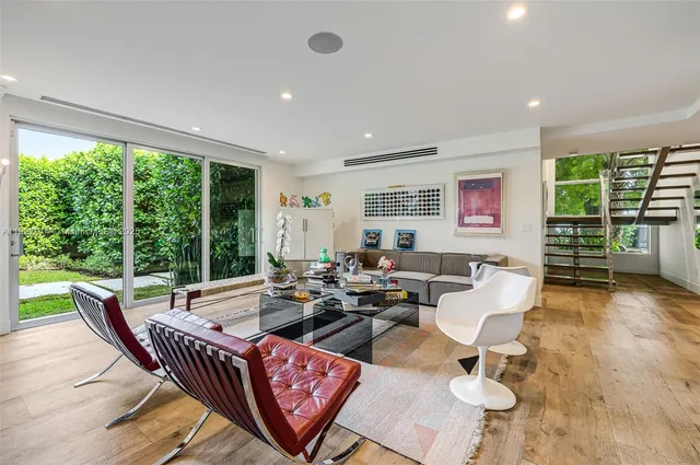 a living room with furniture and large window