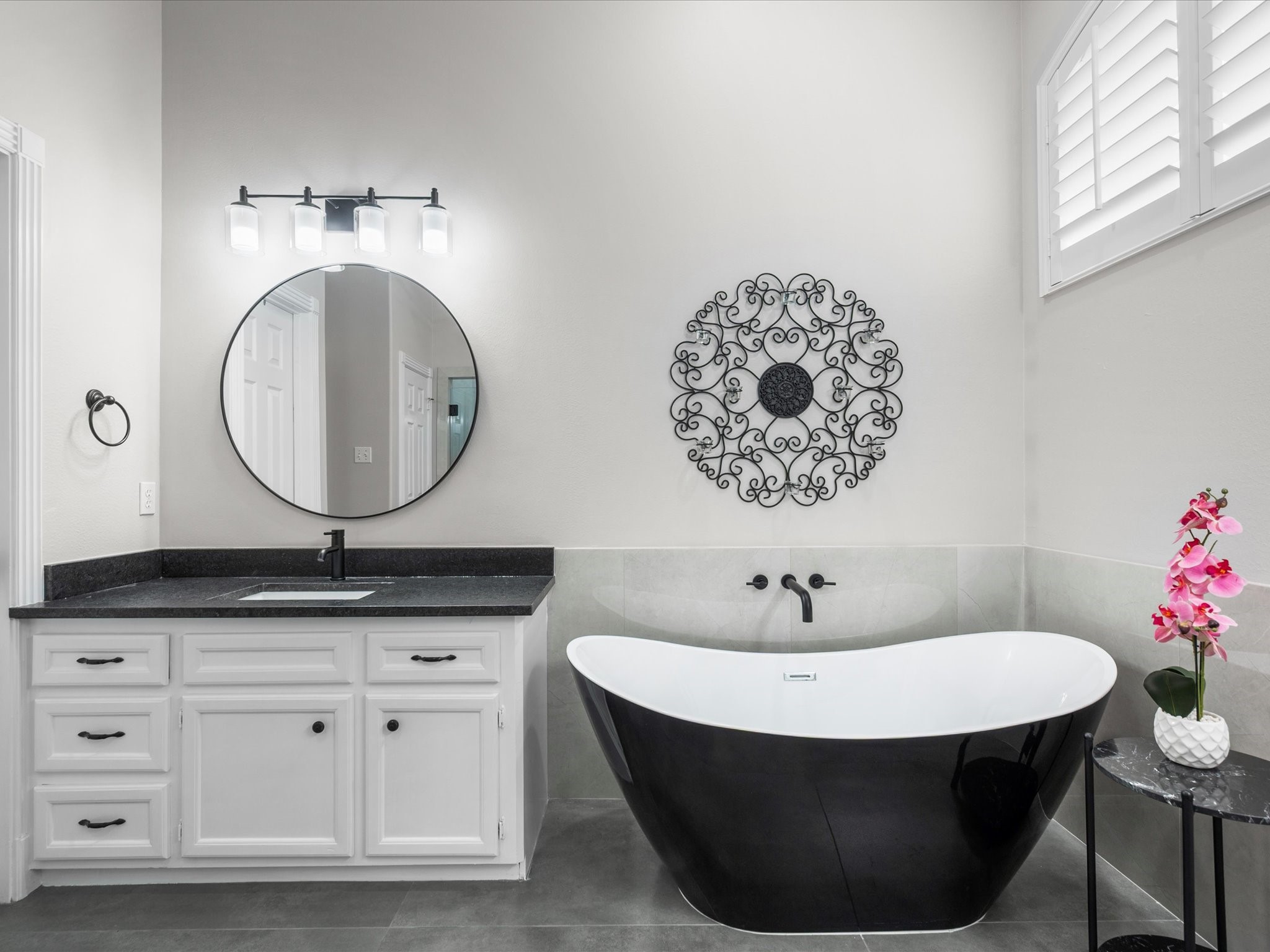 5910 Center Ct Drive Spring, TX 77379 - Photo 23 of 50 The sleek, modern soaking tub offers a calm focal point within the space, designed to feel both sculptural and inviting in a setting that emphasizes relaxation and refinement.