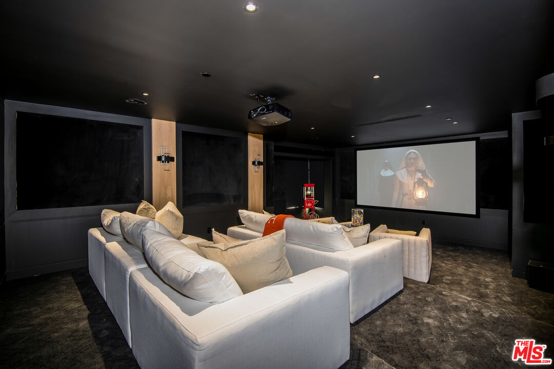 26 Baymare Road Bell Canyon, CA 91307 - Photo 19 of 39 a living room with furniture and a projector screen
