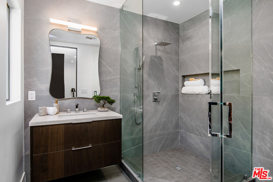 26 Baymare Road Bell Canyon, CA 91307 - Photo 31 of 39 a bathroom with a shower sink and mirror