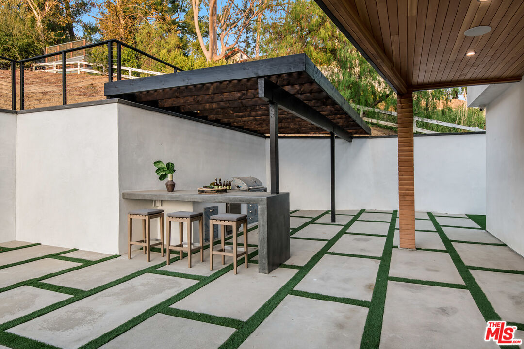 26 Baymare Road Bell Canyon, CA 91307 - Photo 36 of 39 a view of a patio with table and chairs with wooden floor and fence