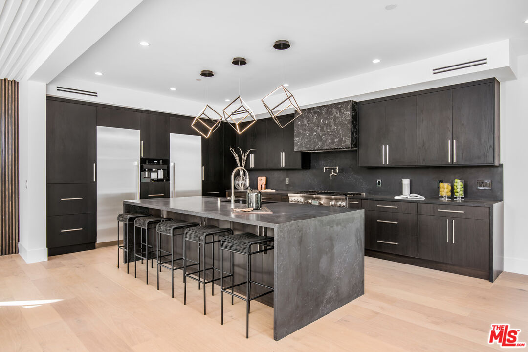 26 Baymare Road Bell Canyon, CA 91307 - Photo 10 of 39 a kitchen with stainless steel appliances granite countertop a stove a sink a refrigerator and chairs