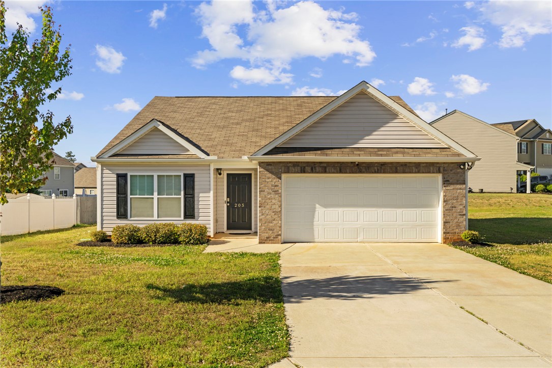 This charming home features a classic brick and siding exterior with a welcoming front entrance.