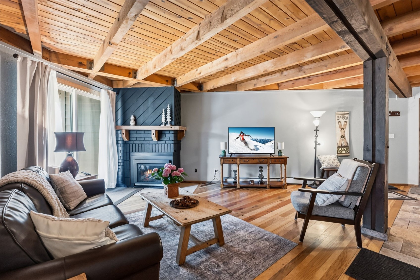 8500 Ryan Gulch Road, Unit 206 Silverthorne, CO 80498 - Photo 1 of 34 a living room with furniture and a fireplace