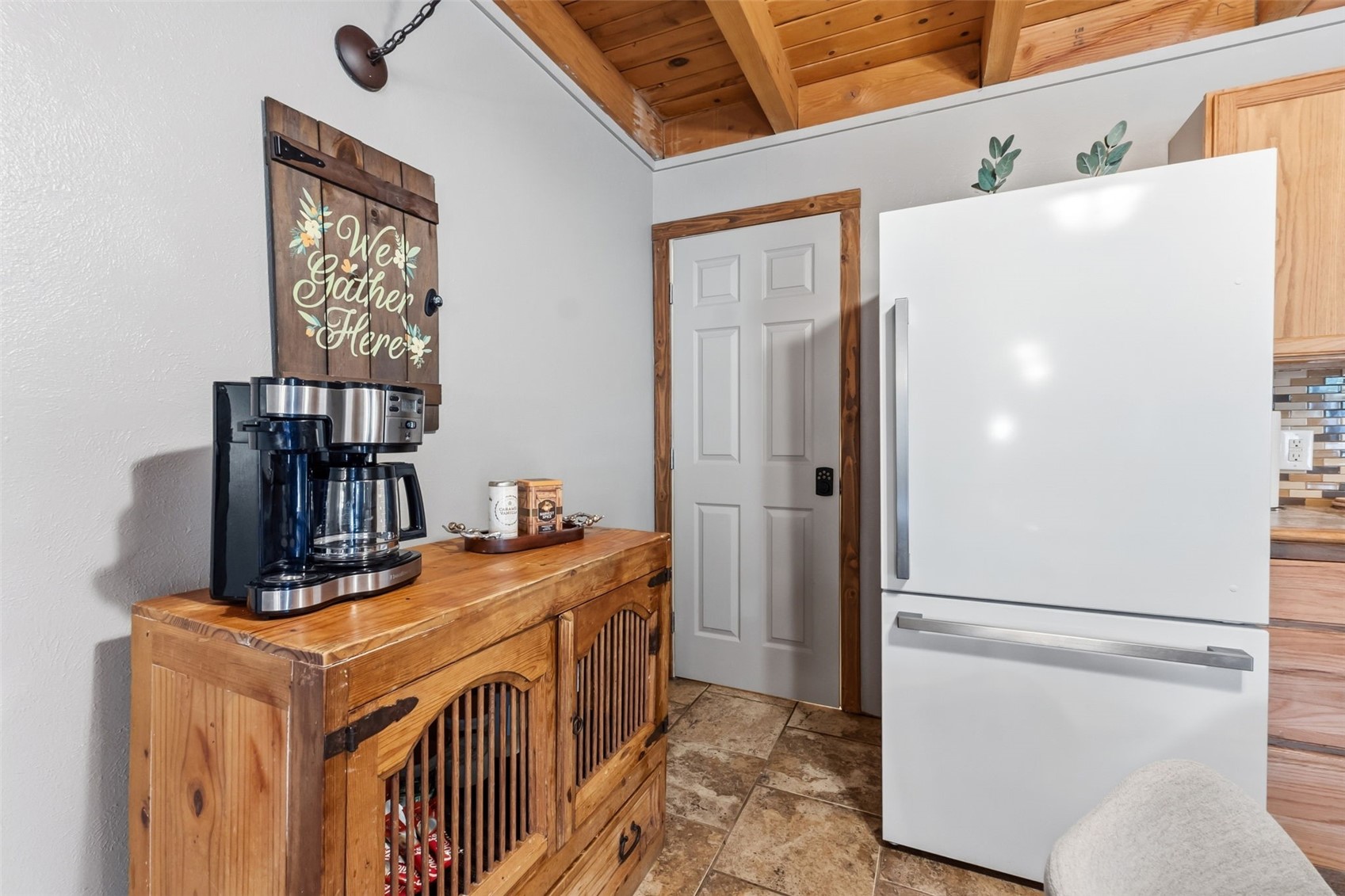 8500 Ryan Gulch Road, Unit 206 Silverthorne, CO 80498 - Photo 13 of 34 a view of a kitchen with fridge and wooden floor