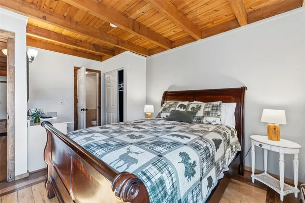 a bedroom with a bed and a large mirror