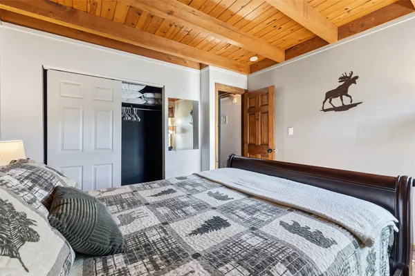 a bedroom with a large bed and a large mirror