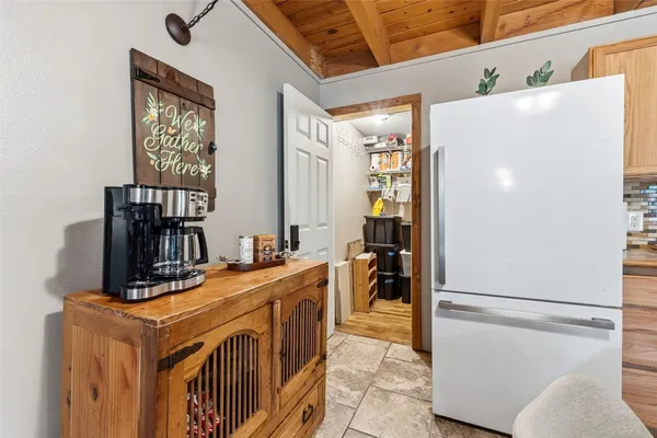 a kitchen with stainless steel appliances granite countertop a refrigerator a stove and a refrigerator