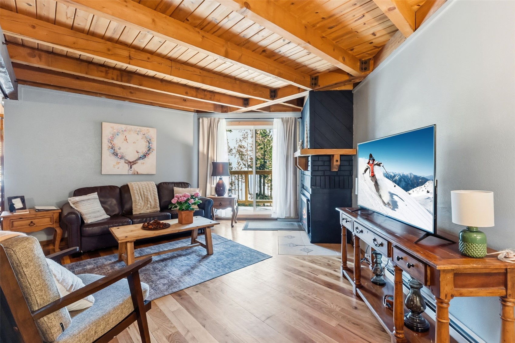 8500 Ryan Gulch Road, Unit 206 Silverthorne, CO 80498 - Photo 4 of 34 a living room with furniture and a flat screen tv