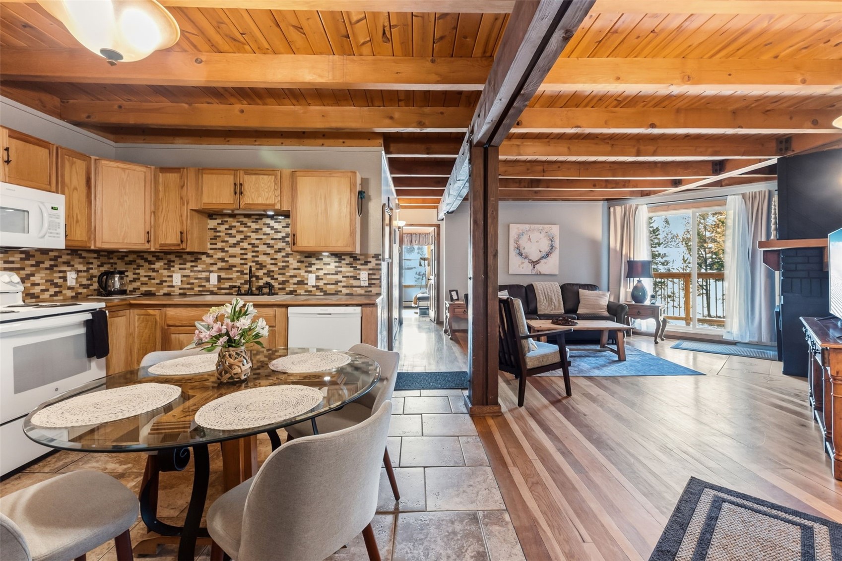 8500 Ryan Gulch Road, Unit 206 Silverthorne, CO 80498 - Photo 7 of 34 a dining room with furniture and wooden floor