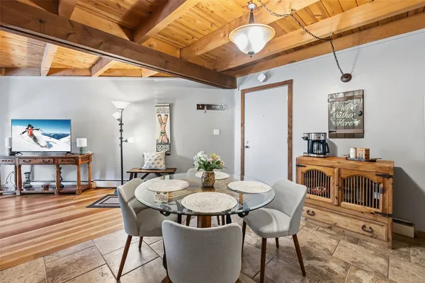 a view of a dining room with furniture and wooden floor