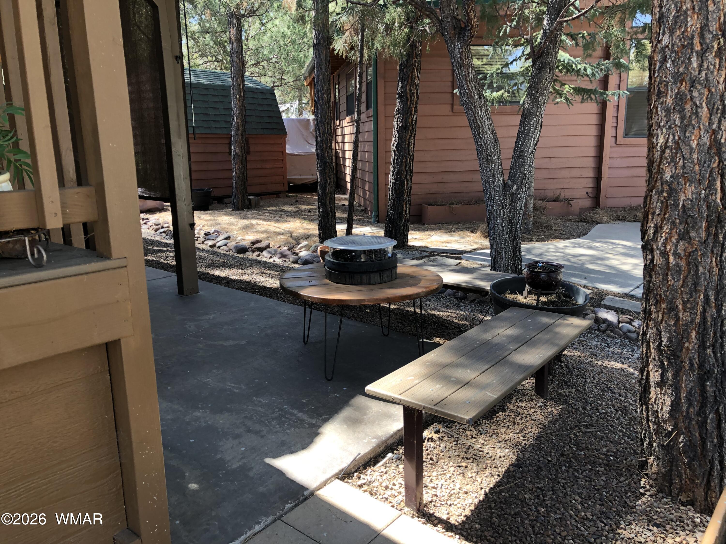 2301 Turtle Creek Road Show Low, AZ 85901 - Photo 5 of 35 a table and chairs sitting in front of a house