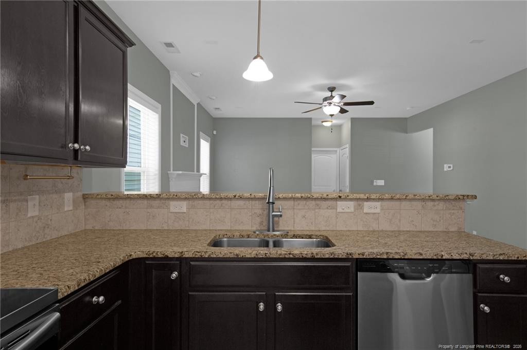 132 Shellbark Drive Spring Lake, NC 28390 - Photo 13 of 44 a kitchen with a sink and a refrigerator