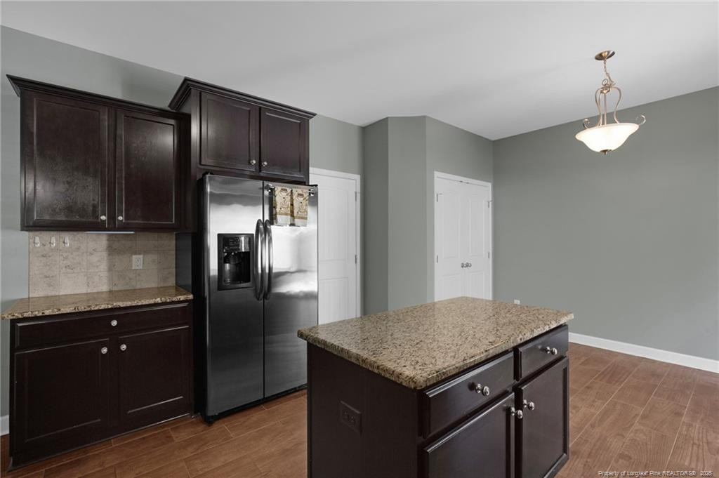 132 Shellbark Drive Spring Lake, NC 28390 - Photo 15 of 44 a kitchen with granite countertop stainless steel appliances a refrigerator and a counter space