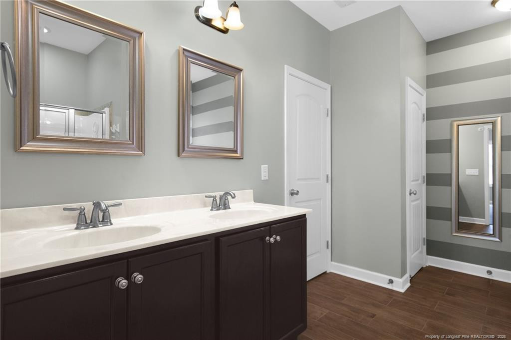 132 Shellbark Drive Spring Lake, NC 28390 - Photo 21 of 44 a bathroom with a double vanity sink and mirror