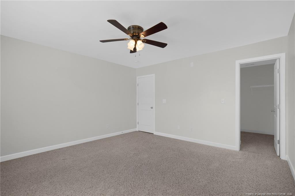 132 Shellbark Drive Spring Lake, NC 28390 - Photo 35 of 44 a view of a big room with wooden floor a ceiling fan and windows