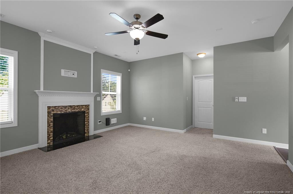 132 Shellbark Drive Spring Lake, NC 28390 - Photo 8 of 44 a view of a livingroom with a fireplace and a ceiling fan