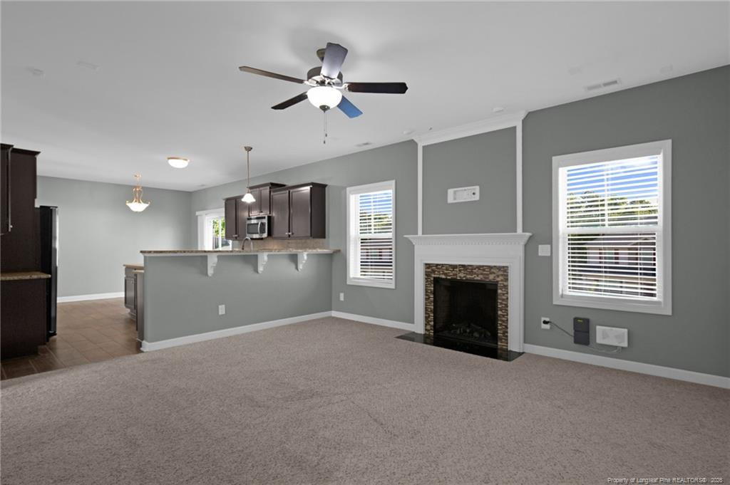 132 Shellbark Drive Spring Lake, NC 28390 - Photo 9 of 44 a view of a livingroom with a fireplace a chandelier and windows
