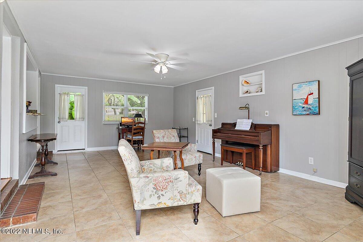 6136 Duke Road Jacksonville, FL 32217 - Photo 10 of 23 a living room with furniture a piano and a window