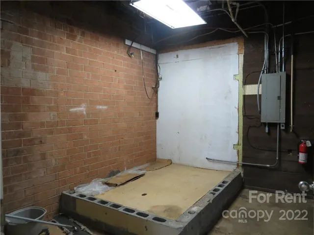 a bathroom with a granite countertop sink and blue shower