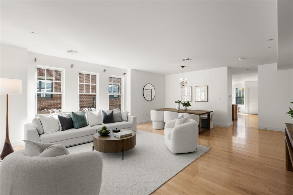 125 Crowninshield Road, Unit 125 Brookline, MA 02446 - Photo 4 of 21 a living room with furniture and wooden floor