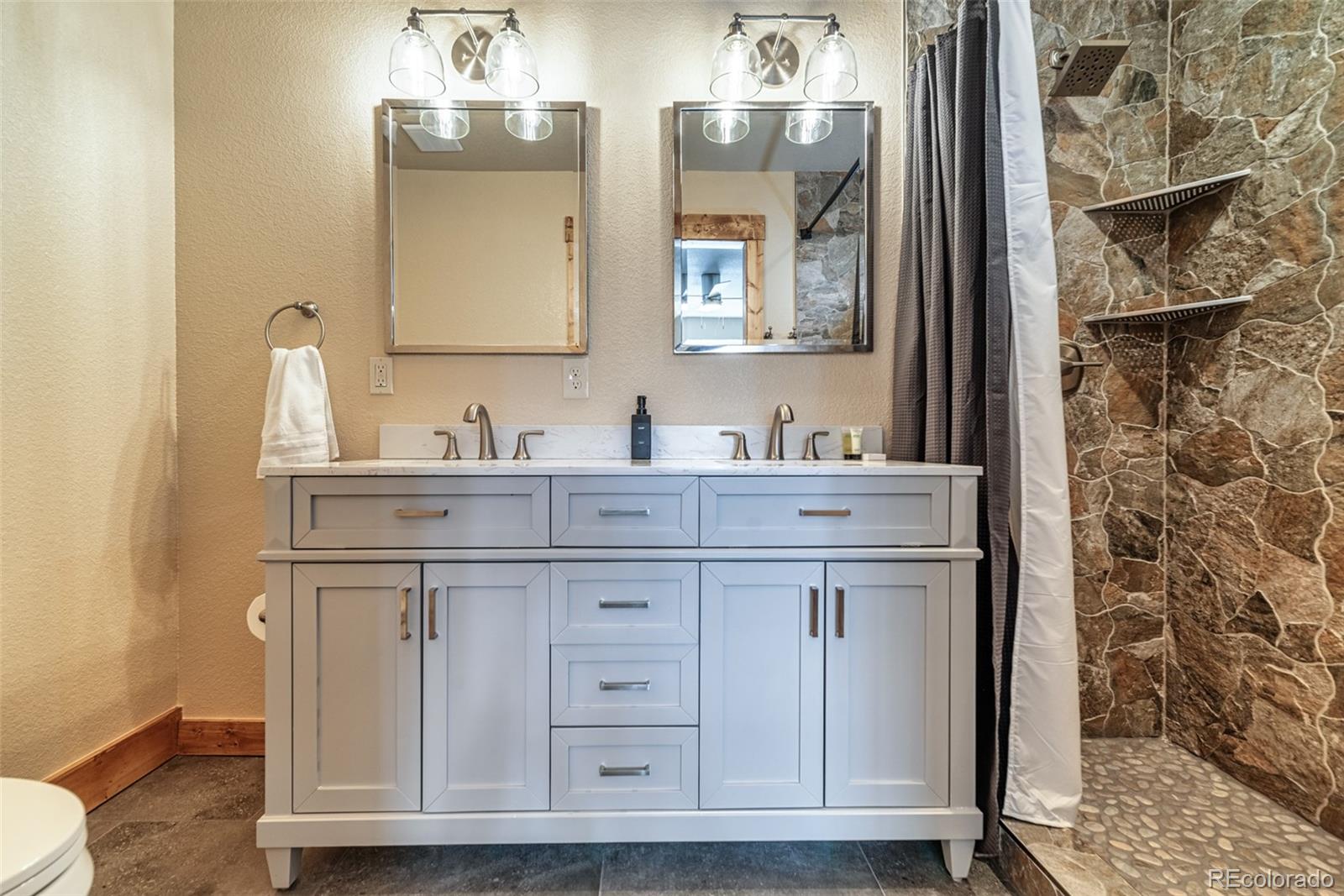 526 Porcupine Road Fairplay, CO 80440 - Photo 21 of 46 a bathroom with cabinets two sinks and a mirror