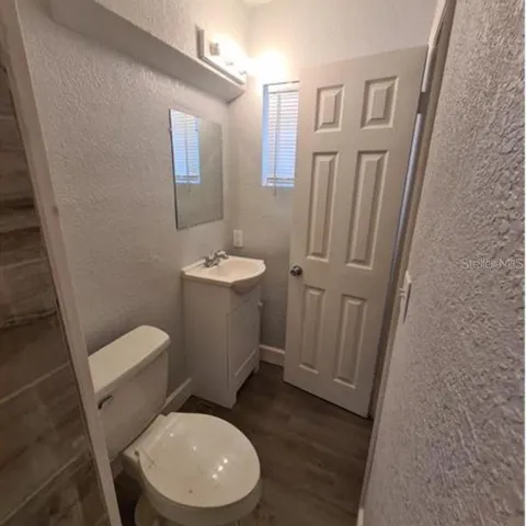 a white toilet sitting next to a bathroom sink