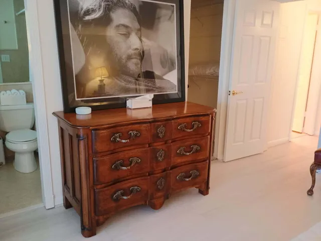 a room with a dresser and a mirror