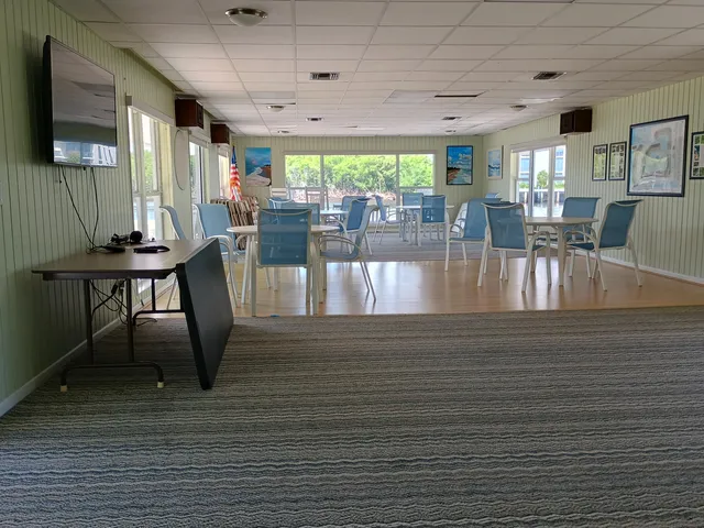 a view of a dining room with furniture a rug and wooden floor