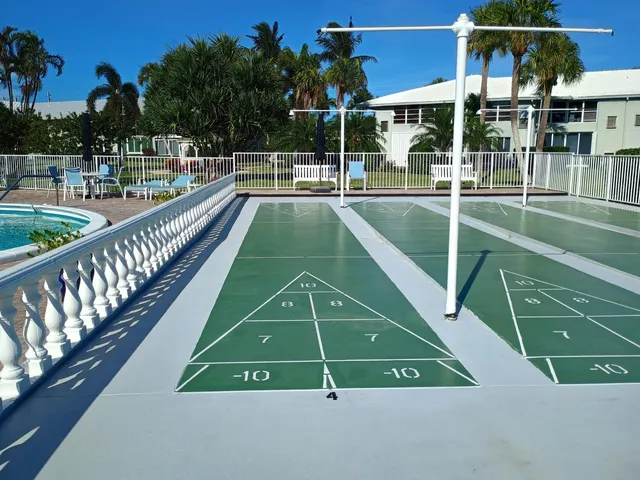 a view of a swimming pool with a patio and a yard of the house