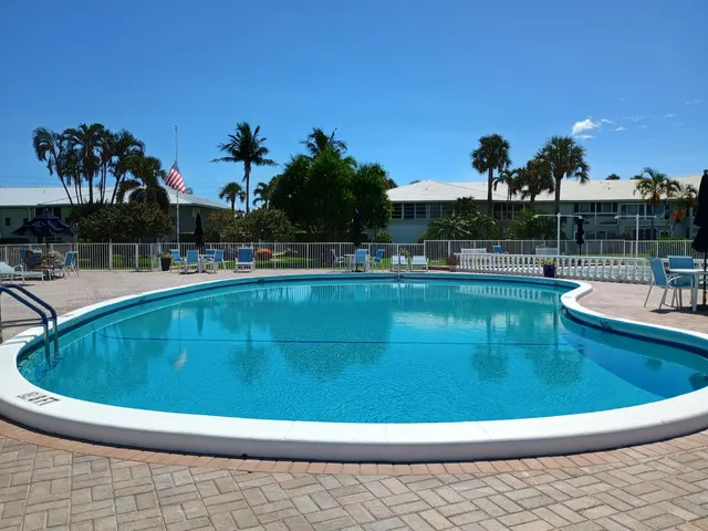 a view of a swimming pool with a yard