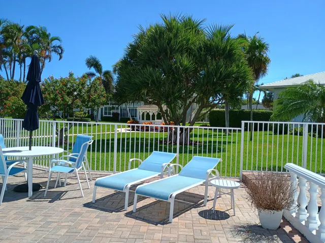 a view of a chair and tables front of the house